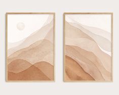 two framed art pieces with mountains in the background