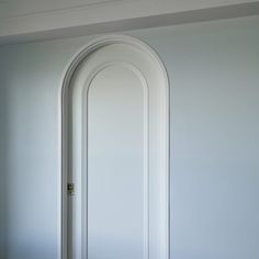 an arched door in the corner of a room