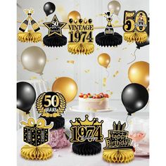 black and gold 50th birthday party supplies including balloons, streamers, cake toppers and decorations