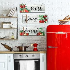 a red refrigerator freezer sitting next to a stove top oven in a kitchen with white brick walls