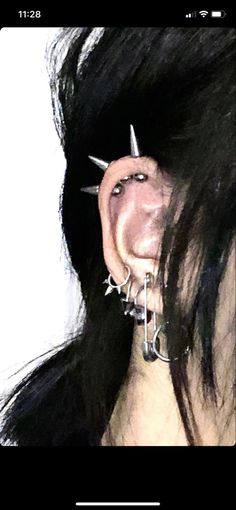 a woman with piercings on her ears and nose