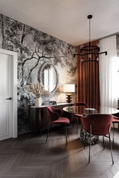 an elegant dining room with red chairs and wallpaper