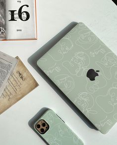 an iphone case sitting on top of a table next to a book and some other items