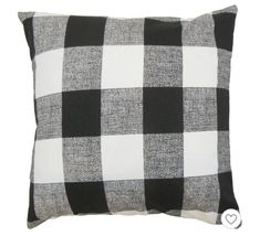 a black and white checkered pillow on a white background