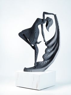 a black and white sculpture of a woman dancing