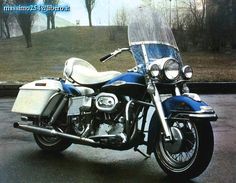 a blue and white motorcycle parked on the street