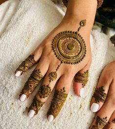 a woman's hands with hennap on it and her hand painted in gold