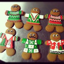 several gingerbread men and women decorated with christmas sweaters