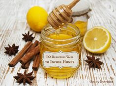 a jar of honey surrounded by cinnamon, lemon and star anise