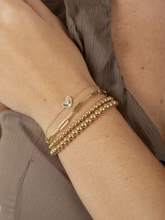 Adorn your wrist with the elegance of our Hailey Heart Fluted Bracelet, an exquisite piece from our Hailey Heart Collection. This 14k gold bracelet features a fluted heart charm, beautifully surrounded by a halo of sparkling round diamonds. Perfect for adding a touch of romantic sophistication to any look, this bracelet is a timeless symbol of love and grace. Bracelet On Wrist, Tennis Jewelry, Gold Heart Bracelet, Timeless Symbol, Religious Jewelry, Gold Filled Jewelry, Gold Heart, Heart Bracelet, Bracelet Stack