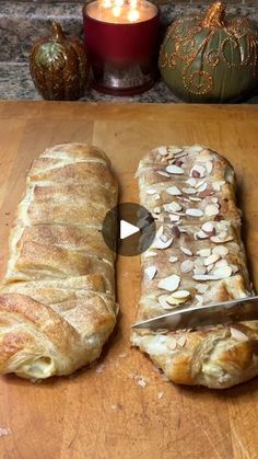 a loaf of bread sitting on top of a wooden cutting board next to a knife