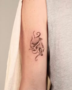 an octopus tattoo on the left arm