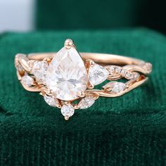 a close up of a ring on top of a green velvet cushion with diamonds in it