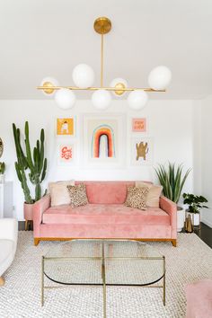 a living room filled with furniture and lots of plants