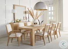 a dining room table and chairs in front of a large window