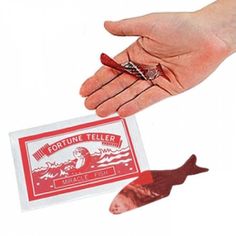 a person's hand holding a fortune teller card