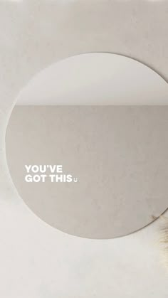 a round mirror with the words you've got this written in white on it