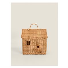 a wicker bag with a small house on the front