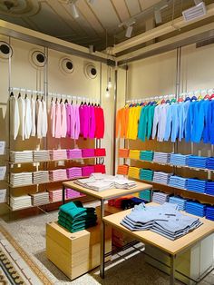 a clothing store with rows of shirts hanging from the ceiling