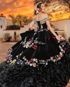 THIS DRESS IS  MADE  TO  ORDER Enjoy a perfect fit in your own custom made to measure dress. --------------------------------------------------- Celebrate your  Quinces with elegance and style! Introducing our dazzling black quinceanera dress with floral embroidery, a unique and exquisite creation that will make you feel like a true princess on your big day.  This stunning dress has been designed with meticulous attention to detail, combining the sophistication of black  velvet and organza, with the delicacy of beautiful floral embroidery. The fitted bodice flatters your figure,  it has a lace-up, corset back, that allows easy adjustability, thus highlighting your curves, while the off-shoulder neckline adds a touch of elegance and subtlety. Delicate floral embroidery  in deep and light pa Vaquera Quinceanera Dress, Day Of The Dead Quinceanera Dresses, Black Charro Quince Dress, Charro Dresses Quinceanera, Gothic Quinceanera, Black Quince Dress, Black Quinceanera Dress, Mariachi Costume, Folklorico Dresses