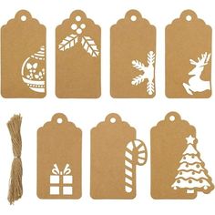 paper tags with christmas decorations on them and a string attached to the tag's side