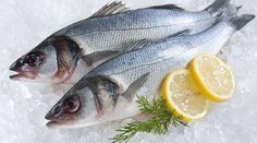 two fish on ice with lemons and rosemary