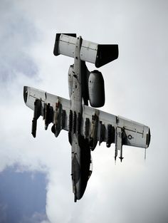 an airplane is flying in the sky with its landing gear down