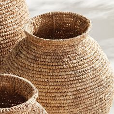 two woven baskets sitting next to each other