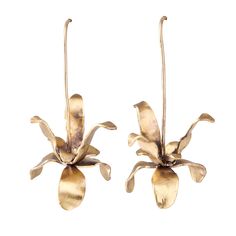 two gold toned flower shaped earrings with long stems and leaves hanging from the ends, on a white background