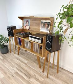 an entertainment center with record players and speakers