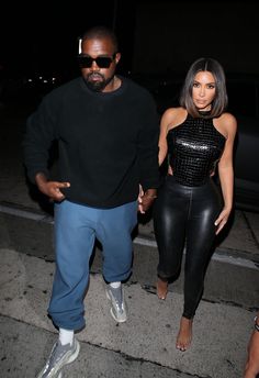 kimye and rapper khloe are seen walking hand in hand through the street