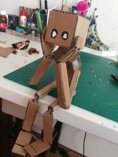 a cardboard robot sitting on top of a table