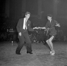 two people are dancing in an old photo