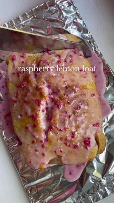 raspberry lemon loaf on foil with a knife