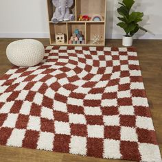 a brown and white area rug with an elephant toy on the floor next to it