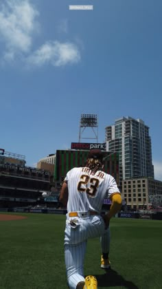 a baseball player kneeling down on the field