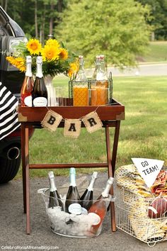 an outdoor bar cart with drinks and snacks