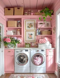 a washer and dryer in a pink laundry room with flowers on the shelves