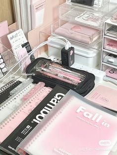 various items are arranged on a table in a room with pink walls and clear acrylic