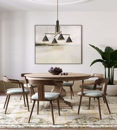 a dining room table with four chairs and a bowl of fruit on the table in front of it