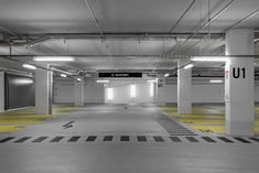 an empty parking garage with yellow and black stripes on the floor is pictured in this image