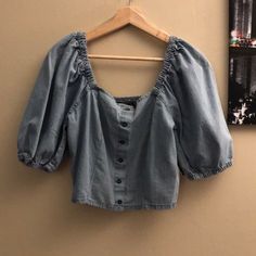 Nwt Taxi Women's Denim Button Down Crop Top. Size L Large. Denim Color/Design. Balloon 3/4 Sleeves - Could Be Worn Off Shoulders. Stretch. 100% Cotton. Machine Wash. Brand New With Tags, Never Worn. See Photos For Approximate Measurements (Measurements Taken In Front Of A Big Window In Sunlight) *Disclosure For All Items In My Closet* - Pet Free/Smoke Free House - Color May Show On Your Screen As Different Shades On Different Devices - Some Items May Have Small Pinholes From Security Sensors Fro Summer Medium Wash Denim Top With Puff Sleeves, Medium Wash Denim Top With Puff Sleeves For Summer, Medium Wash Puff Sleeve Denim Top For Summer, Summer Puff Sleeve Denim Top, Washed Blue Top With Button Closure For Day Out, Washed Blue Tops With Button Closure For Day Out, Trendy Washed Cotton Blouse, Light Indigo Cotton Tops With Button Closure, Light Wash Chambray Top With Button Closure