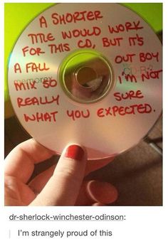 someone is holding up a cd with writing on it and the caption reads, i'm strangely proud of this