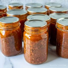 several jars filled with food sitting on top of a table