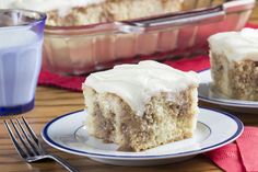 a piece of cake sitting on top of a white plate next to a glass of milk