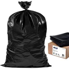 a black trash bag next to a cardboard box