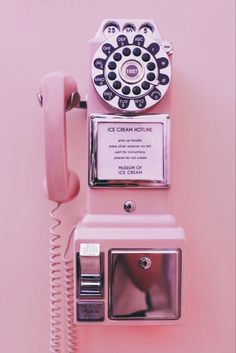 an old fashioned pink pay phone on a pink background