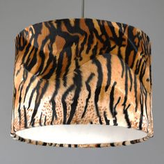 an animal print lamp shade hanging from a ceiling fixture