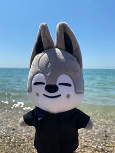 a stuffed animal is standing on the beach