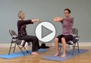 two people sitting on chairs in a gym, one is stretching the other's arm